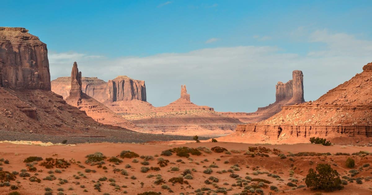 Wide desert landscape in Nevada with mountains in the background under a clear blue sky