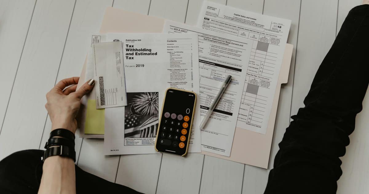 Financial documents and calculator on a desk representing loan comparison